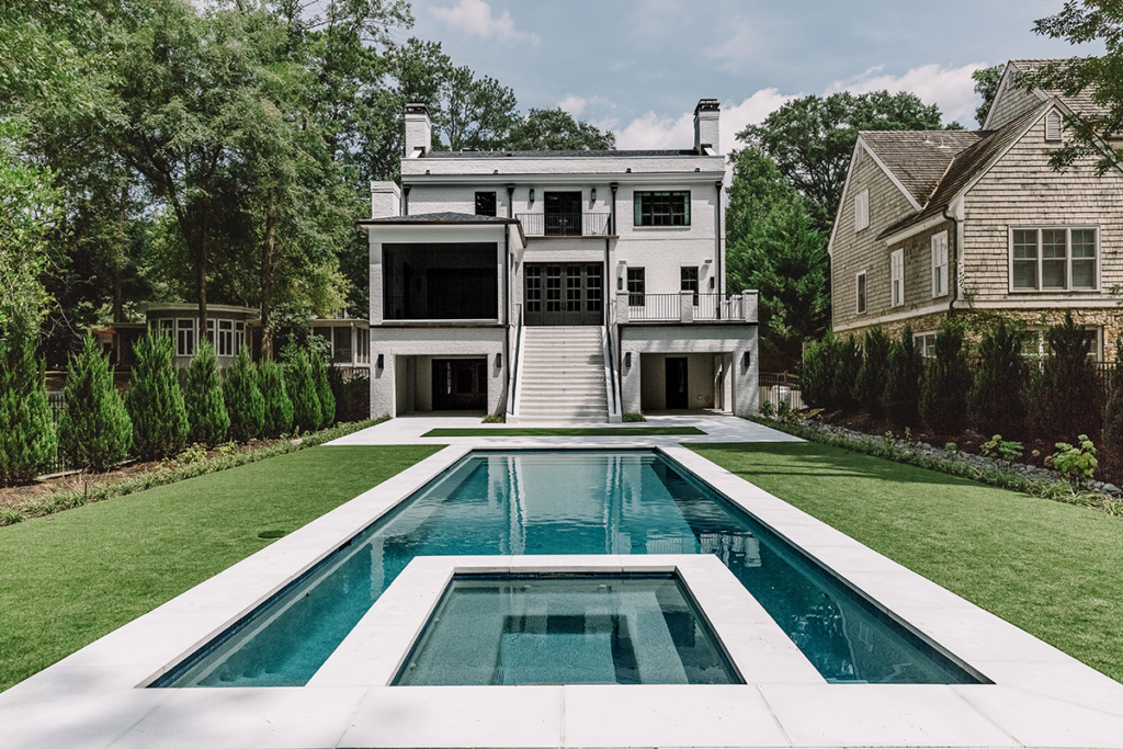 Pool surrounded by white pavers